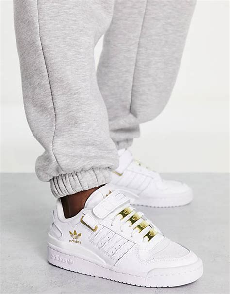 adidas originals forum low trainers in white with gold details